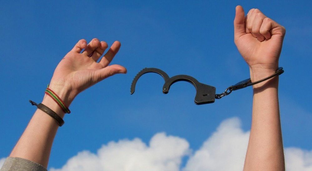 opioid use disorder. Hands breaking free of handcuffs