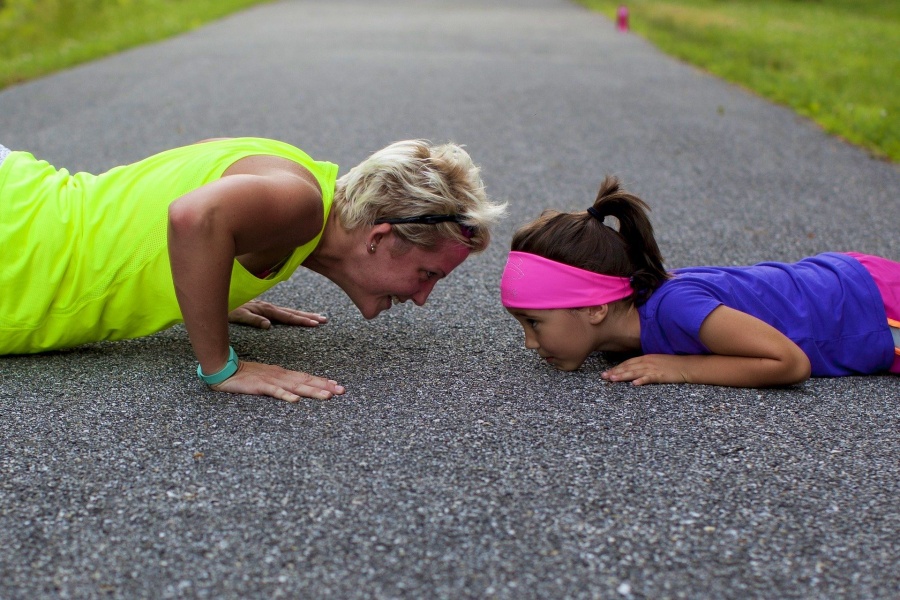 healthy aging. Older woman and young girl doing push ups